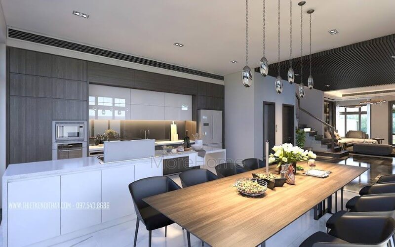 Bàn ăn gỗ nguyên tấm mộc mạc kết hợp đồ nội thất hiện đại sẽ là lựa chọn ấn tượng tạo nên không gian độc đáo cho phòng ăn liền bếp. Thiết kế nội thất phòng ăn biệt thự